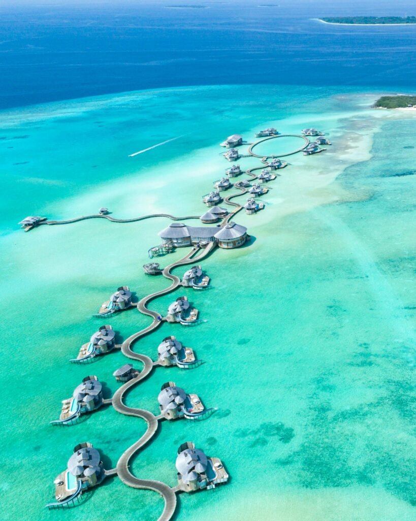 pexels-photo-678725-678725 Aerial view of luxury overwater villas at Noonu Atoll, Maldives with turquoise waters.